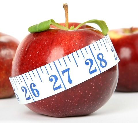 red apples with measuring tape